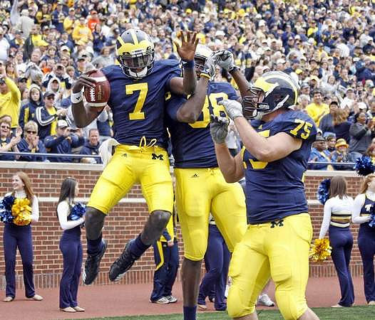Devin Gardner (7), Brandon Moore (88), and Michael Schofield (75)