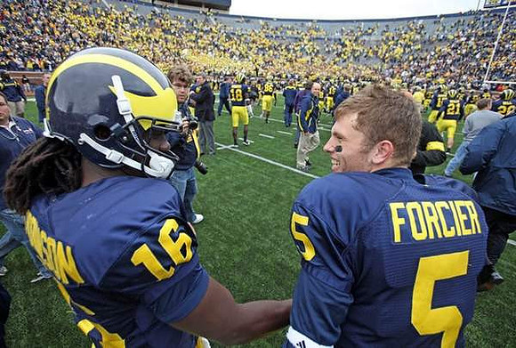 Denard Robinson (16) and Tate Forcier (5)