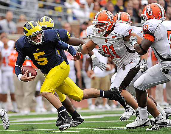 Tate Forcier (5) and Patrick Omameh (65)