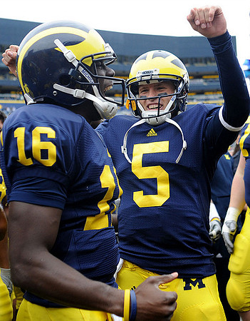 Denard Robinson (16) and Tate Forcier (5)