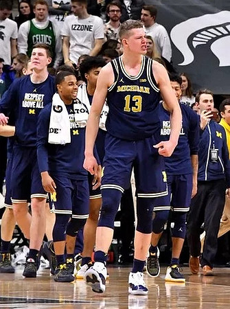 Moritz Wagner (13) and Michigan Team