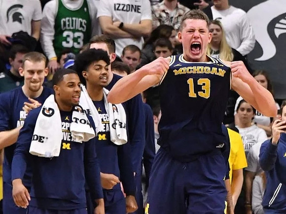 Moritz Wagner (13) and Michigan Team