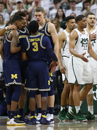 Charles Matthews (1), Zavier Simpson (3), Isaiah Livers (4), and Moritz Wagner (13)