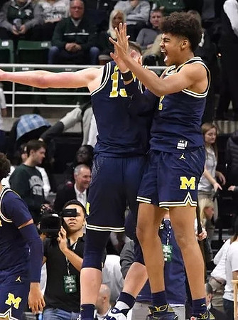 Moritz Wagner (13) and Jordan Poole (2)