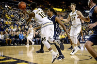 Duncan Robinson (22), Derrick Walton Jr. (10), and Mark Donnal (34)