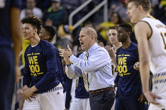 D.J. Wilson (5), John Beilein, Caris LeVert (23), and Moritz Wagner (13)