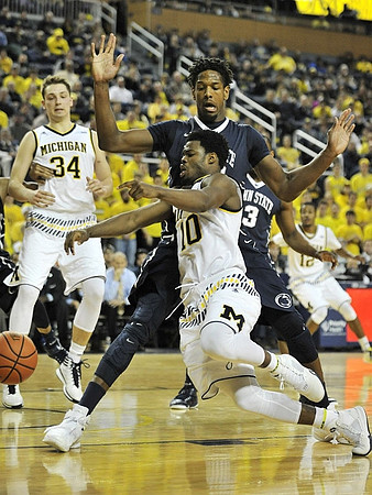 Mark Donnal (34), Derrick Walton Jr. (10), and Muhammad-Ali Abdur-Rahkman (12)
