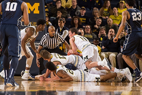 Derrick Walton Jr. (10), Moritz Wagner (13), Zak Irvin (21), and Andrew Dakich (11)