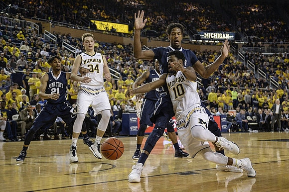 Mark Donnal (34) and Derrick Walton Jr. (10)