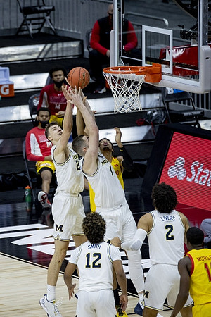 Franz Wagner (21), Hunter Dickinson (1), Mike Smith (12), and Isaiah Livers (2)
