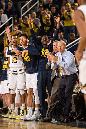 Muhammad-Ali Abdur-Rahkman (12), D.J. Wilson (5), Caris LeVert (23), Jeff Meyer, and John Beilein