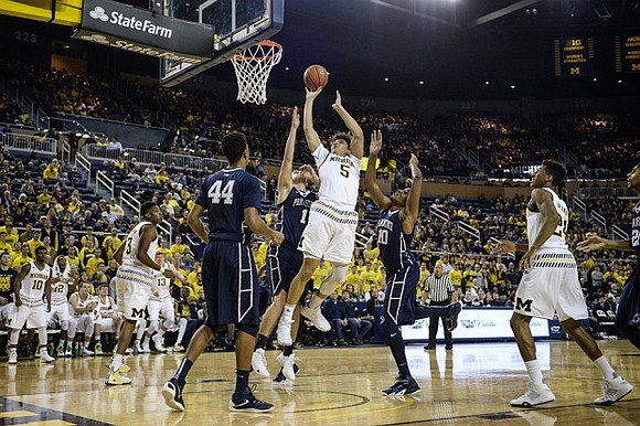 Derrick Walton Jr. (10), Kameron Chatman (3), D.J. Wilson (5), and Zak Irvin (21)