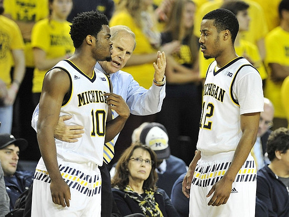 Derrick Walton Jr. (10), John Beilein, and Muhammad-Ali Abdur-Rahkman (12)