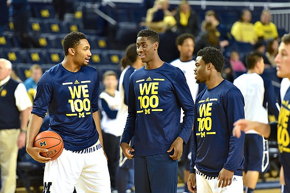 Zak Irvin (21), Caris LeVert (23), and Derrick Walton Jr. (10)