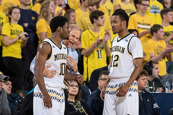 Derrick Walton Jr. (10), John Beilein, and Muhammad-Ali Abdur-Rahkman (12)