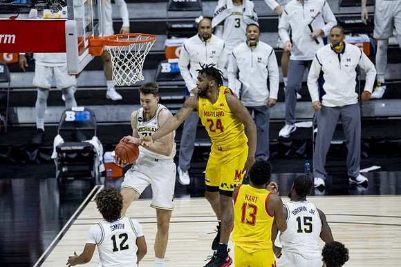 Mike Smith (12), Franz Wagner (21), and Chaundee Brown Jr. (15)