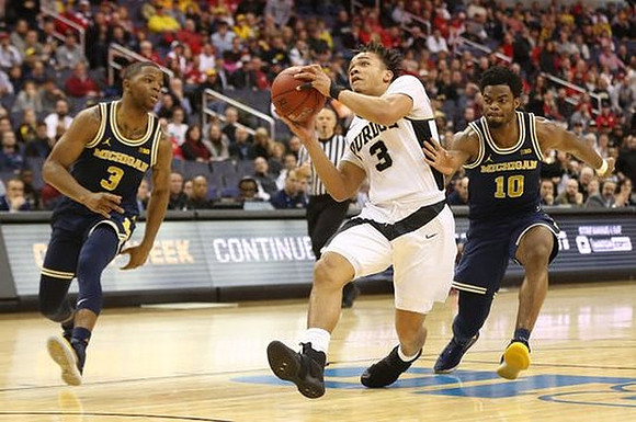 Xavier Simpson (3) and Derrick Walton Jr. (10)