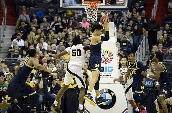 Zak Irvin (21), D.J. Wilson (5), Muhammad-Ali Abdur-Rahkman (12), and Derrick Walton Jr. (10)