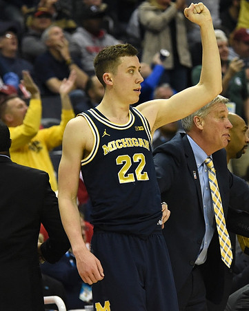 Duncan Robinson (22), Jeff Meyer, and Saddi Washington