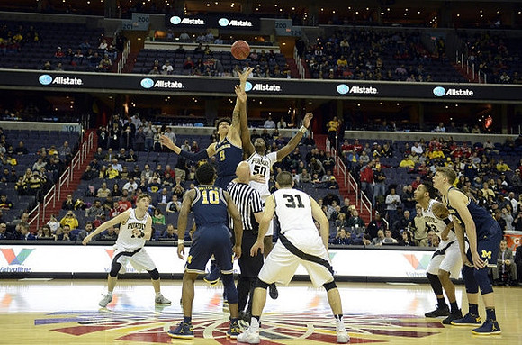Derrick Walton Jr. (10), D.J. Wilson (5), and Moritz Wagner (13)