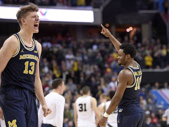 Moritz Wagner (13) and Derrick Walton Jr. (10)