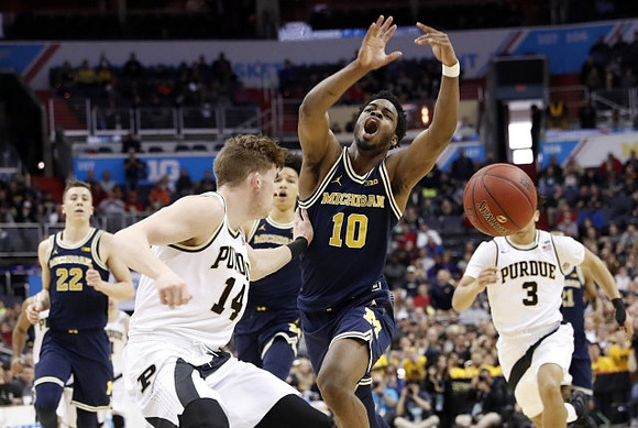 Derrick Walton Jr. (10), D.J. Wilson (5), and Duncan Robinson (22)