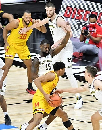 Chaundee Brown Jr. (15), Hunter Dickinson (1), and Franz Wagner (21)