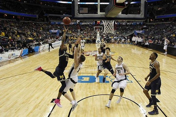 Muhammad-Ali Abdur-Rahkman (12), D.J. Wilson (5), and Zak Irvin (21)