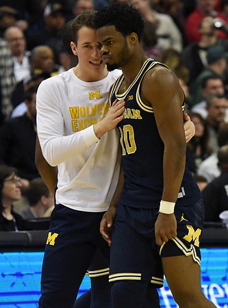 Andrew Dakich (11) and Derrick Walton Jr. (10)