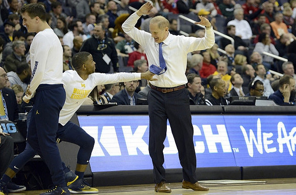 Andrew Dakich (11), Xavier Simpson (3), and John Beilein