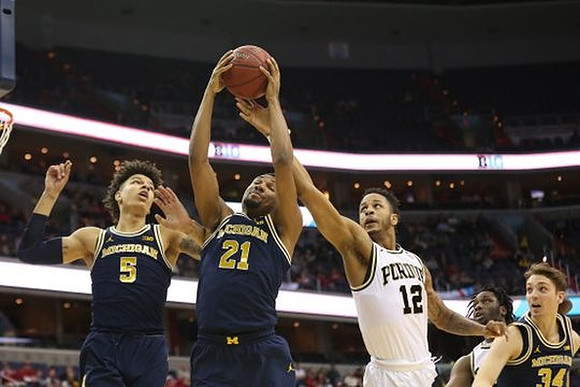 D.J. Wilson (5), Zak Irvin (21), and Mark Donnal (34)