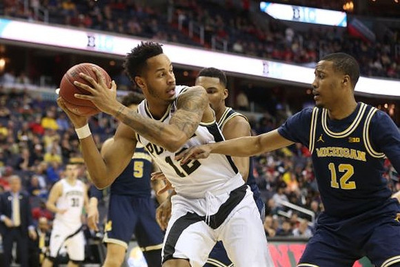 Muhammad-Ali Abdur-Rahkman (12), Zak Irvin (21), and D.J. Wilson (5)