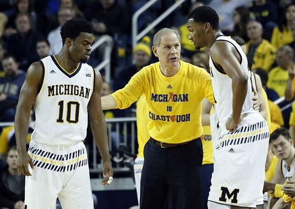 Derrick Walton Jr. (10), John Beilein, and Zak Irvin (21)