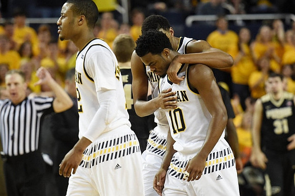 Muhammad-Ali Abdur-Rahkman (12), Zak Irvin (21), and Derrick Walton Jr. (10)
