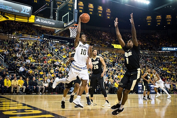 Derrick Walton Jr. (10) and Zak Irvin (21)