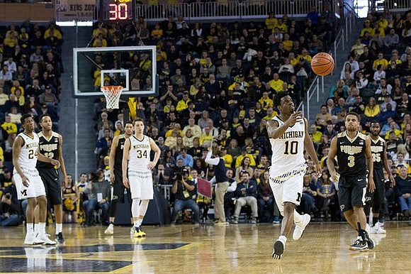 Aubrey Dawkins (24), Mark Donnal (34), and Derrick Walton Jr. (10)