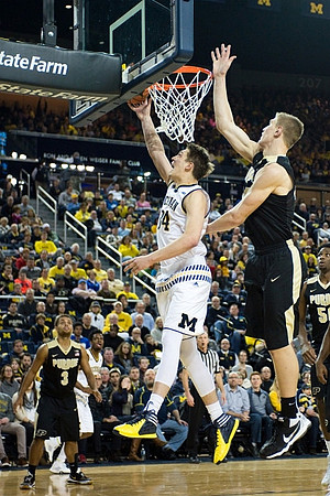 Mark Donnal (34) and Derrick Walton Jr. (10)