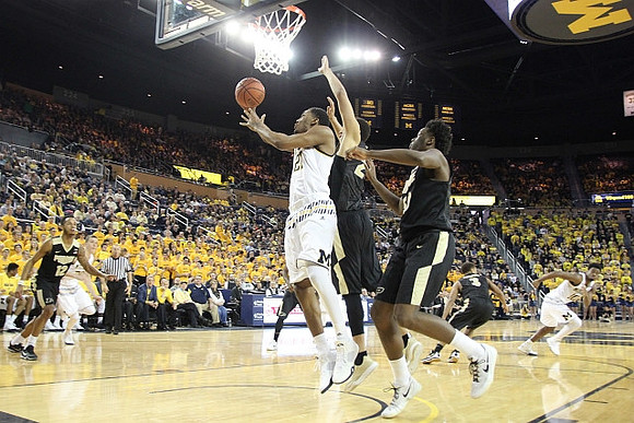 Zak Irvin (21) and Derrick Walton Jr. (10)