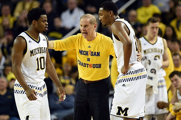 Derrick Walton Jr. (10), John Beilein, and Zak Irvin (21)