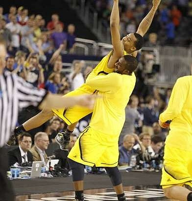 Trey Burke (3) and Corey Person (32)