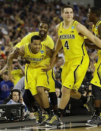 Trey Burke (3), Corey Person (32), Mitch McGary (4), and Caris LeVert (23)