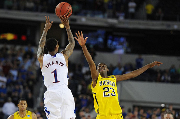 Trey Burke (3) and Caris LeVert (23)
