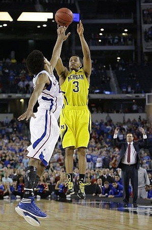 Trey Burke (3) and Kansas Head Coach Bill Self
