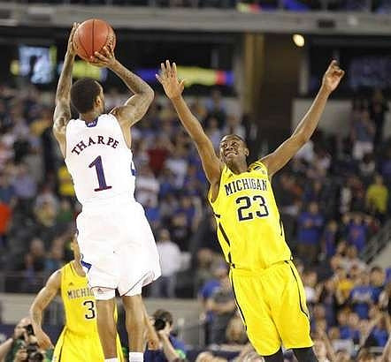 Trey Burke (3) and Caris LeVert (23)