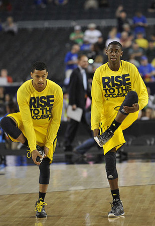 Trey Burke (3) and Caris LeVert (23)