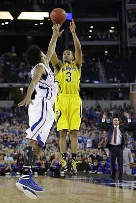 Trey Burke (3) and Kansas Head Coach Bill Self