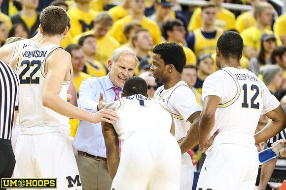 Duncan Robinson (22), John Beilein, Charles Matthews (1), Zavier Simpson (3), and Muhammad-Ali Abdur-Rahkman (12)