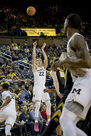 Muhammad-Ali Abdur-Rahkman (12), Duncan Robinson (22), and Charles Matthews (1)