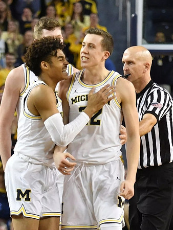 Jordan Poole (2), Jon Teske (15), and Duncan Robinson (22)