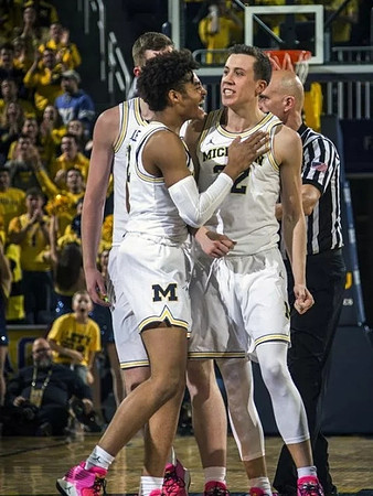 Jordan Poole (2) and Duncan Robinson (22)
